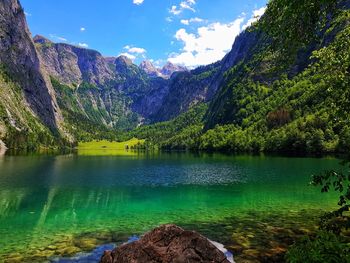 Scenic view of lake and mountains against sky