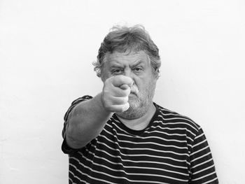 Portrait of man standing against white background