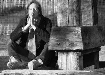 Full length of men sitting on wood