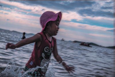 Full length of woman on beach against sky during sunset