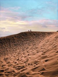 Scenic view of desert against sky during sunset