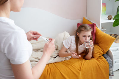 Mother taking care of sick daughter