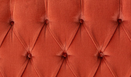 Sofa red velvet fabric texture abstract background.