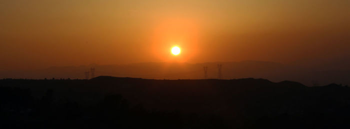 Scenic view of silhouette landscape against romantic sky at sunset