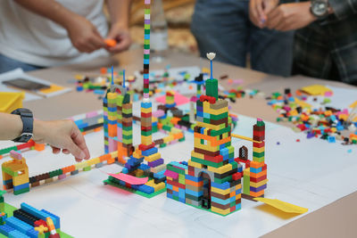 People playing with toy blocks on table