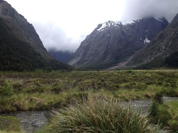 Scenic view of lake and mountains against sky