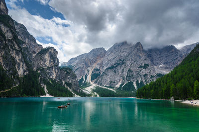 Scenic view of lake by mountains against sky