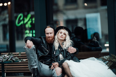 Young couple sitting outdoors