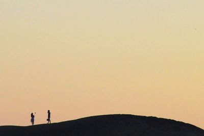 Silhouette of man standing on landscape