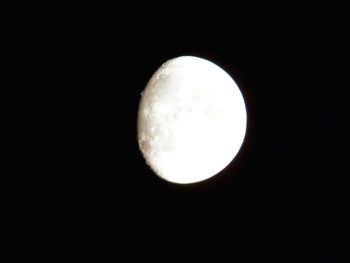 Low angle view of moon against dark sky