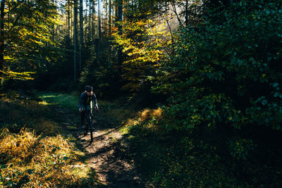 Woman riding a gravel bike in the forest
