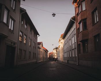 Street amidst residential buildings against sky