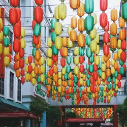 Low angle view of lanterns hanging against sky