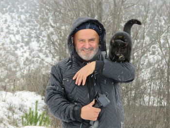 Portrait of a smiling young man in snow