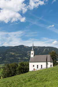 Church and mountains against sky