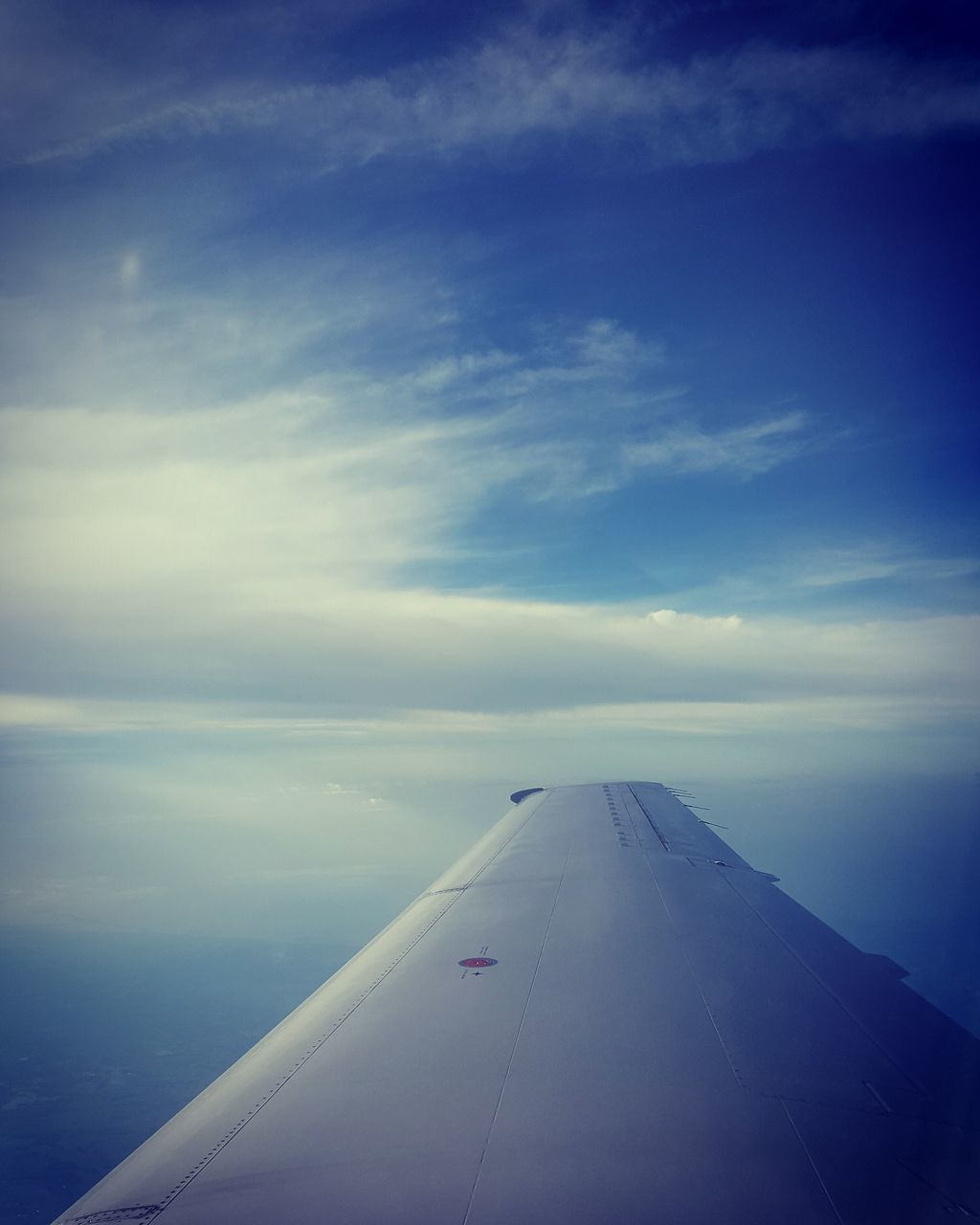 AIRPLANE WING OVER CLOUDS