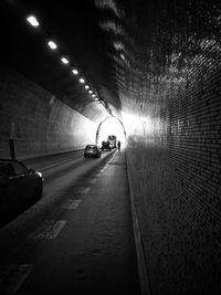 Cars in illuminated tunnel