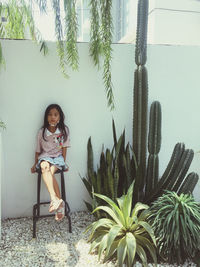 Portrait of young woman sitting on chair