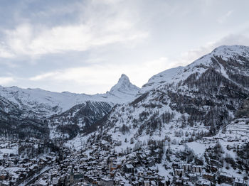 Scenic view of snowcapped mountains against sky