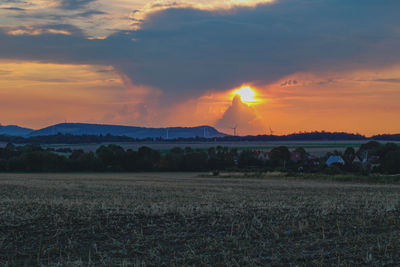 Scenic view of field against sky during sunset