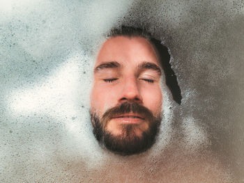 Close-up portrait of shirtless man