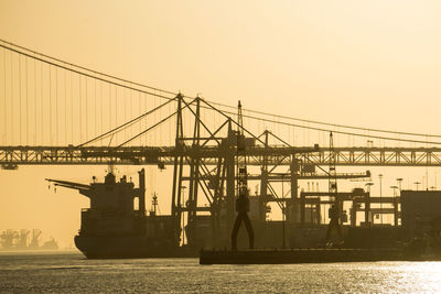 Commercial dock against clear sky during sunset