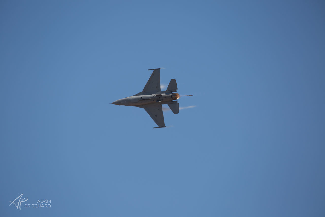 LOW ANGLE VIEW OF AIRPLANE FLYING IN CLEAR SKY