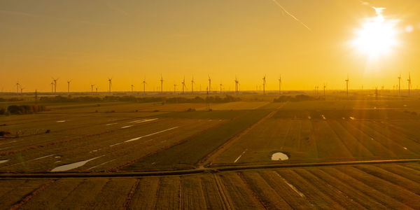 Wind turbines onshore wind farm on the north sea coast at sunset