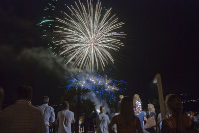 Low angle view of firework display at night