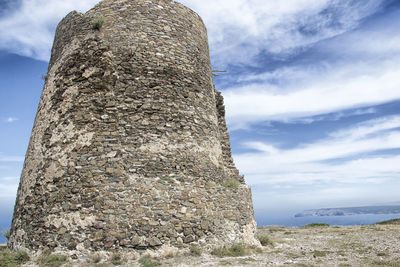 Low angle view of rocks against sky