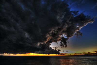 Storm clouds over sea during sunset