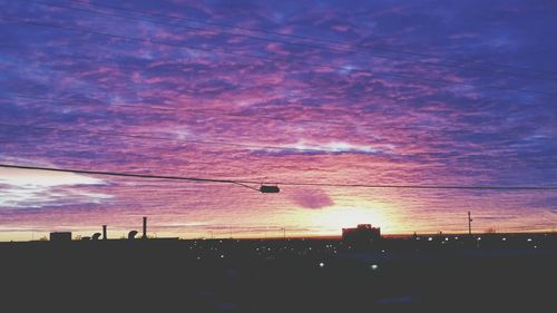Low angle view of power lines against sky