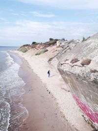 High angle view of woman standing on shore at beach