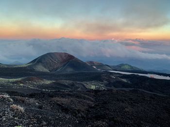 View of volcanic landscape against cloudy sky