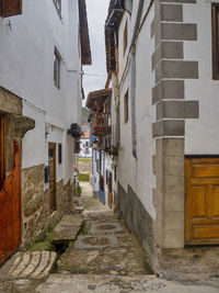 Narrow alley amidst buildings in town