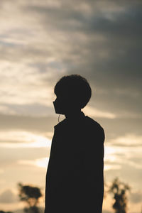 Silhouette man standing against sky during sunset