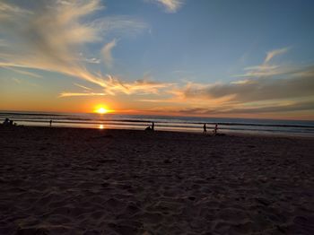 Scenic view of beach against sky during sunset