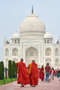 Rear view of people walking on street
