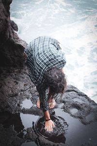 High angle view of man standing on rock