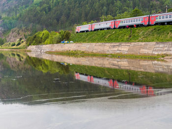 Train on railroad track by lake