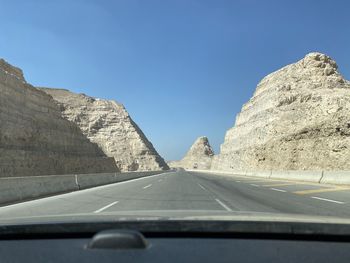 Road against sky seen through car windshield