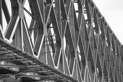 Low angle view of bridge and buildings against sky