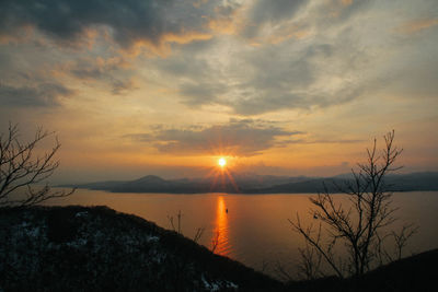 Scenic view of lake against sky during sunset