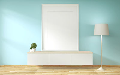 Potted plant on table against wall at home