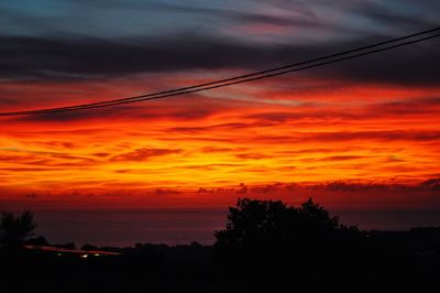 Scenic view of dramatic sky over sea during sunset