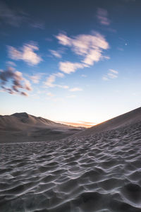 Scenic view of desert against sky during sunset