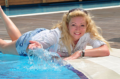 Portrait of smiling young woman in swimming pool