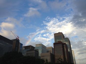 Low angle view of buildings against cloudy sky