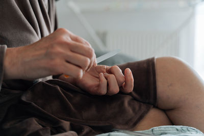 Low section of woman holding hands