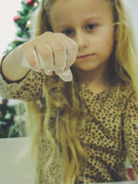 Close-up of cute girl holding camera